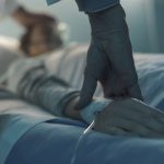 Doctor assisting a young patient at the hospital