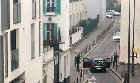 Des armées font face à la police près des bureaux de Charlie Hebdo, le 7 janvier 2015 à Paris (Photo ANNE GELBARD. AFP)