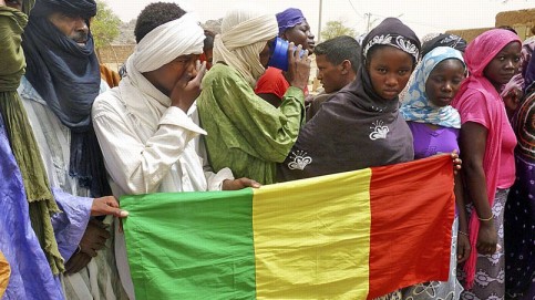 People seeking refuge from Tuareg separatist rebel group MNLA display a Malian flag in a military camp in the northern town of Kidal,