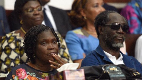 Le 26 décembre, dans le box des accusés, Simone Gbagbo apparaît pour la première fois depuis son arrestation avec son époux en avril 2011. A ses côtés, se tient l'ancien Premier ministre Gilbert Ake N'Gbo, également poursuivi. AFP PHOTO / SIA KAMBOU